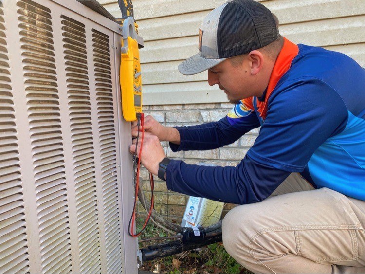 A technician servicing an air conditioner.