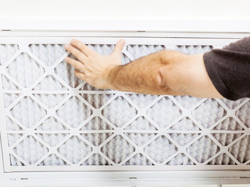 A man is holding an air filter in his hand for the online store.
