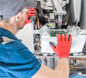 man working on furnace