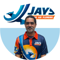 Meet the team: A man in a colorful branded work uniform with a Jay's Heating, Air & Plumbing logo, smiling against a white background.