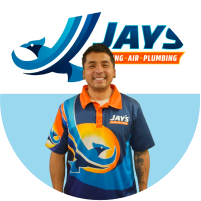 Employee in company uniform standing in front of the jays air conditioning & plumbing logo for the "Meet The Team" section.