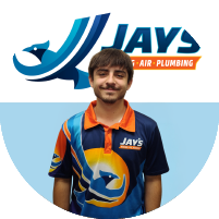 Meet the team: A person wearing a Jay's Heat, Air, Plumbing branded shirt stands in front of the company's logo.