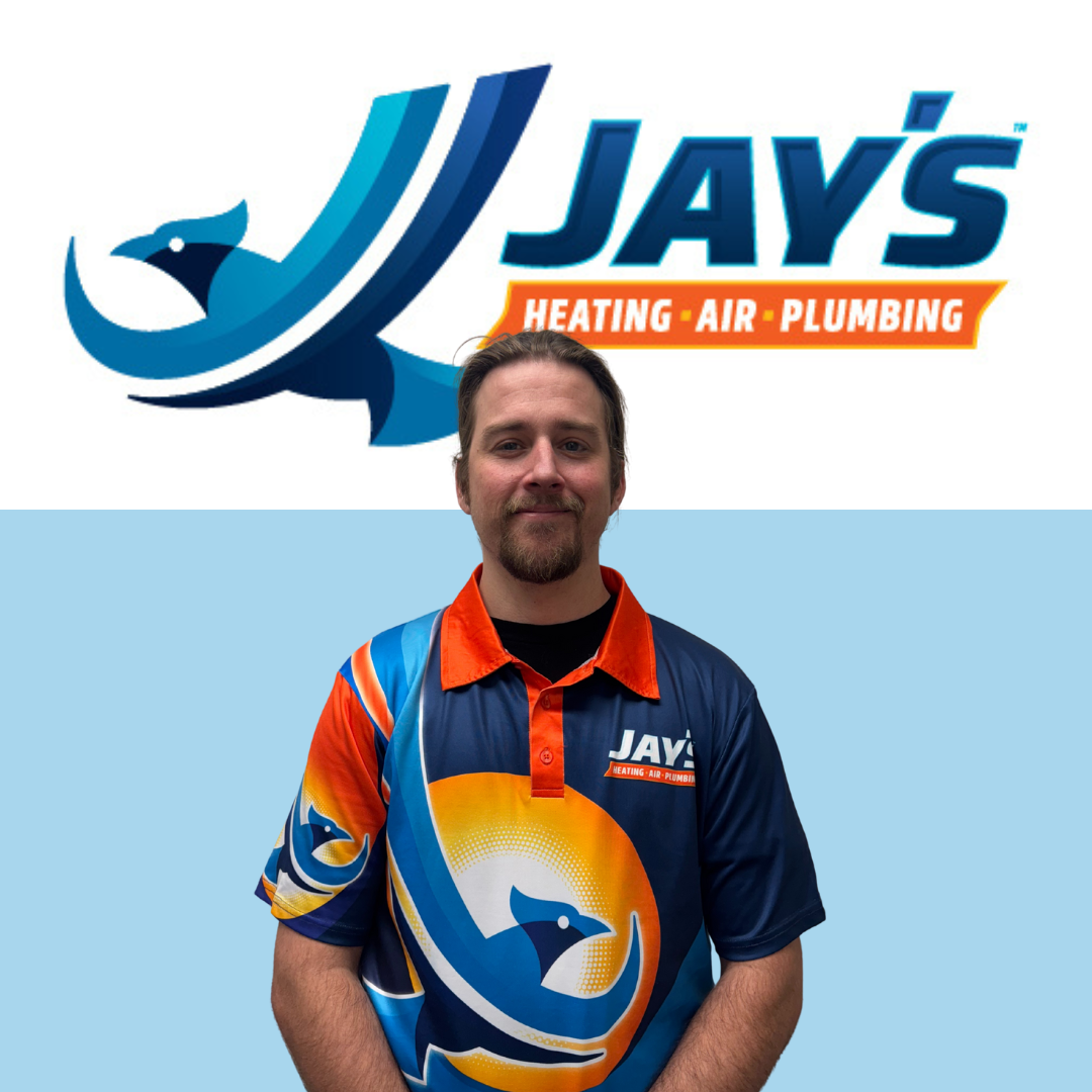 A man wearing a Jay's Heating, Air, Plumbing shirt stands in front of a wall featuring the company's logo.
