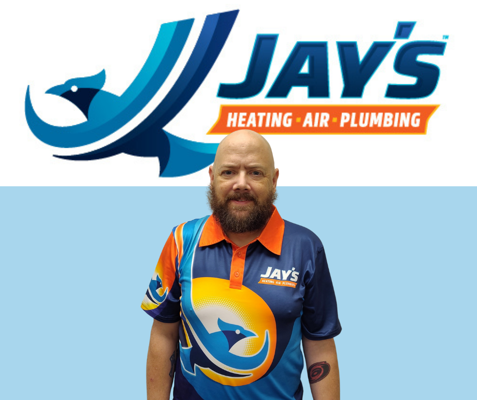 A man wearing a Jay's Heating, Air, Plumbing shirt stands in front of a wall with the company's logo and name displayed above him.